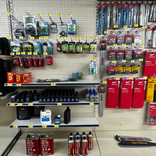 A store display of various power tool accessories and lubricants, neatly organized on shelves and pegboards with clearly visible packaging and labels.